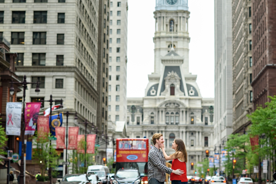 An engaged couple in love with philadelphia in the background.